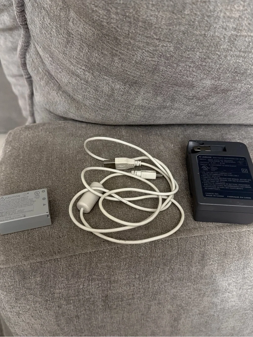 Canon Black Battery Charger with Silver LP-E12 Battery and White USB Cable